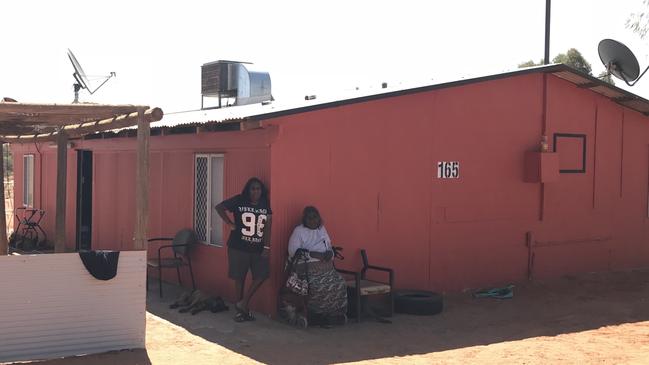 Santa Teresa resident Enid Young (seated) took their Territory government landlords to the NT Civil and Administrative Tribunal after Ms Young was left without a back door on her home for almost six years, among other issues. Picture: Grata Fund