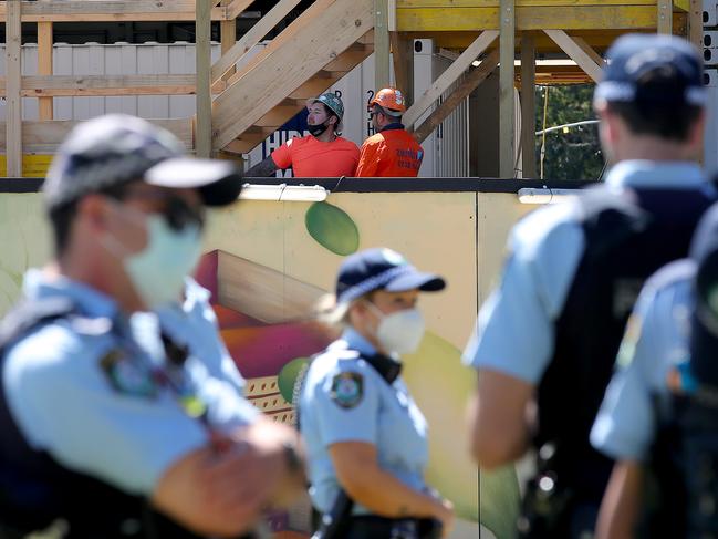 NSW Workers Rally has been organised for Paul Keating Park in Bankstown on the back of the Melbourne protests calling for no vaccine mandates. A heavy police presence seems to have deterred anyone from gathering. Workers from the construction site next to the park keep an eye on proceedings during their break. Picture: Toby Zerna