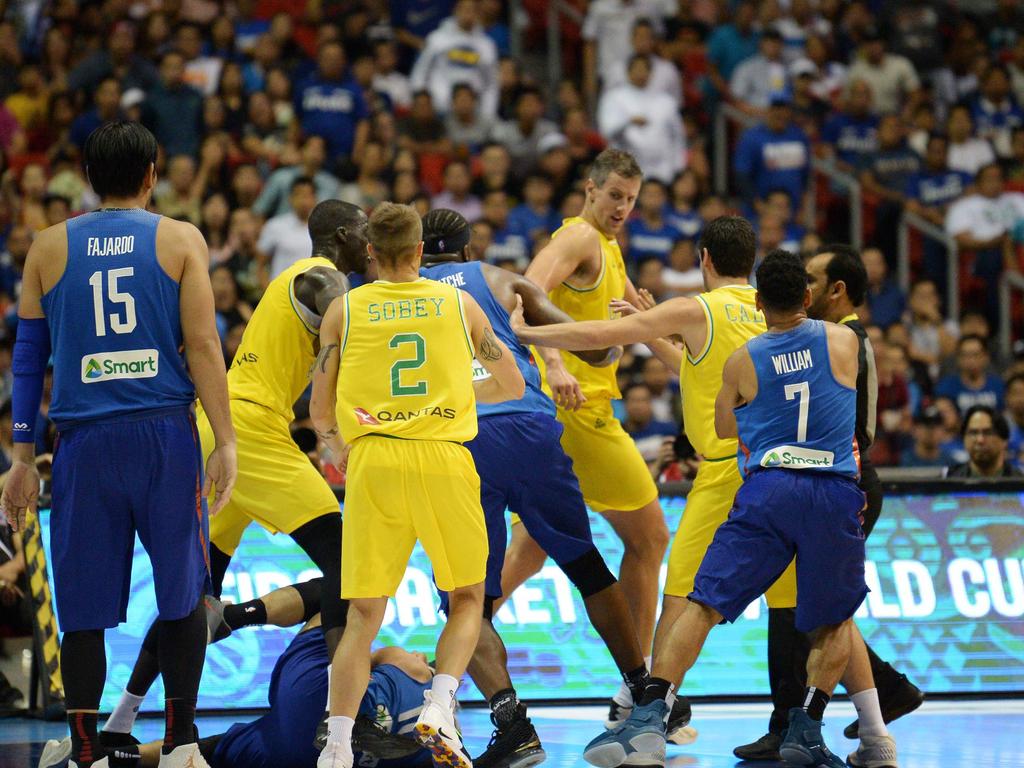 Philippine (blue) and Australian (yellow) players engage in a brawl during their FIBA World Cup Asian qualifier game at the Philippine arena in Bocaue town, Bulacan province, north of Manila on July 2, 2018. Australia won by default 89-53. / AFP PHOTO / TED ALJIBE