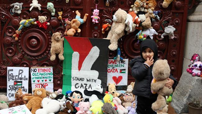 Young children bring teddy bears and other soft toys representing children killed in Gaza, to the gates of the Foreign, Commonwealth and Development Office in London. Picture: AFP