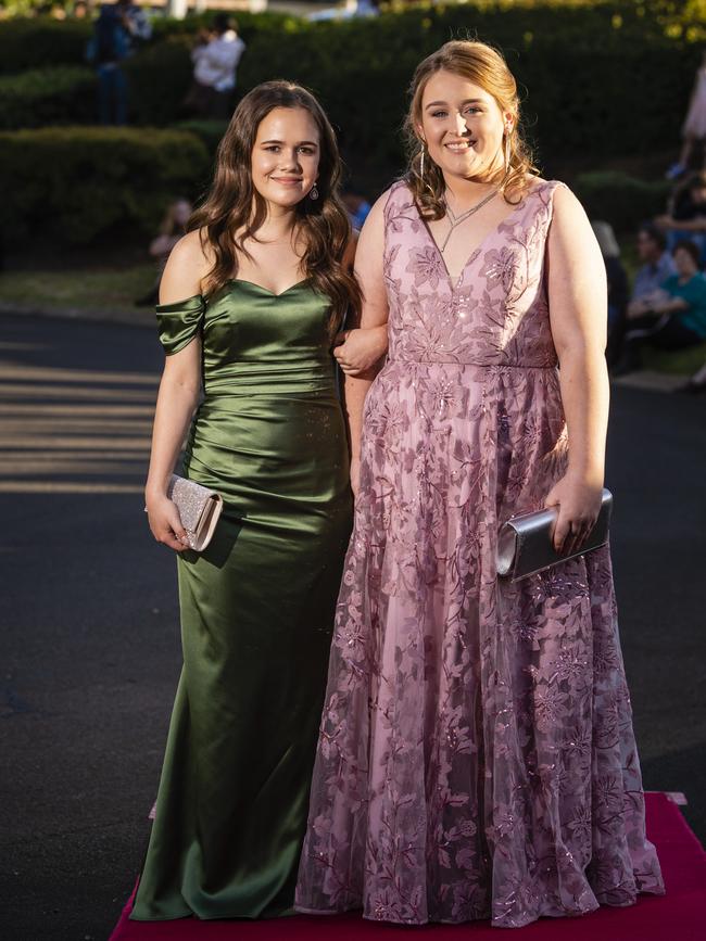 Phebe Waters (left) and Sophie Klowss arrive at Harristown State High School formal at Highfields Cultural Centre, Friday, November 18, 2022. Picture: Kevin Farmer