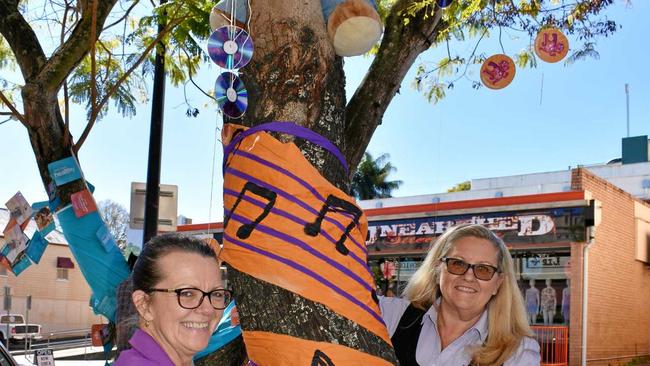 Auswide Bank regional manager Janelle Walsh helps Gympie staff member Sandy Chapman decorate their tree in Mary Street. Picture: DONNA JONES
