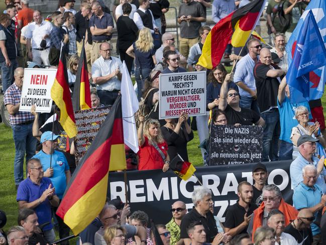 MANNHEIM, GERMANY - 07 JUNE: Supporters of the far-right Alternative for Germany (AfD) party gather originally for a campaign event for the European elections a week after the murder of a police officer by an Afghan immigrant, in Mannheim, Germany, 07 June 2024. The AfD was not allowed to demonstrate in front of the memorial. Around 800 people demonstrated against the rally. The assailant, Sulaiman A., attacked people with a knife at a rally of a far-right political group in Mannheim on May 31, injuring anti-Islam activist Michael Stuerzenberger and fatally wounding police officer Rouven L. Police associations across Germany held a moment of silence today at 11:34 to commemorate his death. The murder has sparked a national debate, with political leaders insisting that Afghans who pose a threat to public safety shall be sent back to Afghanistan. Repatriations to Afghanistan have so far been on hold due to Germany's limited diplomatic relations with the Taliban regime.  (Photo by Thomas Lohnes/Getty Images)