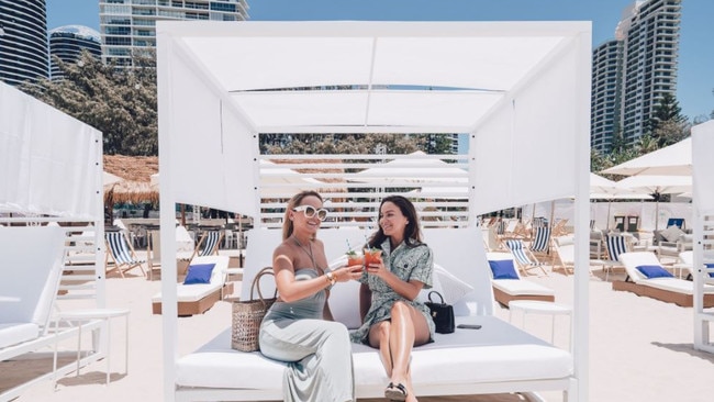 Visitors enjoy a drink at the beach club.