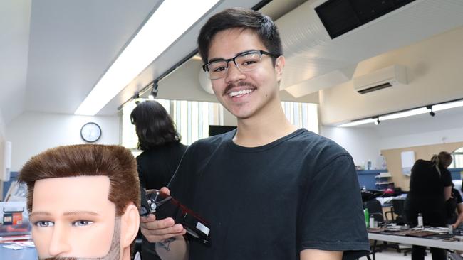 More students, including apprentice barber Denzel Carlos, are being trained to work in the male grooming industry.