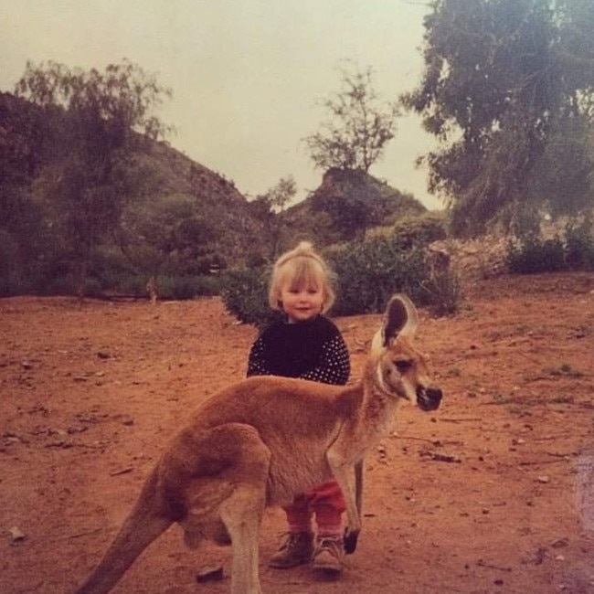 Young Tasmin with a red kangaroo. Picture: SUPPLIED