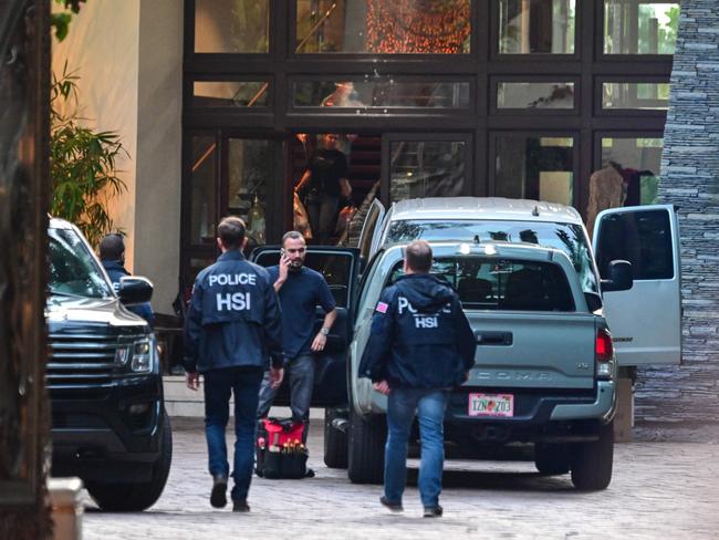 Homeland Security Investigation agents are seen at the entrance of US producer and musician Sean 