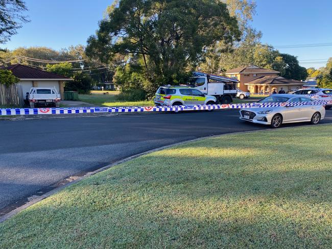 Police have cordoned off Mahogany St at Raceview following a house fire and disturbance early Friday morning in which a man was seriously injured.