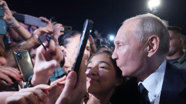 Vladimir Putin poses for selfies with residents of Derbent during his working trip to Russia's Republic of Dagestan. Picture: SPUTNIK / AFP.