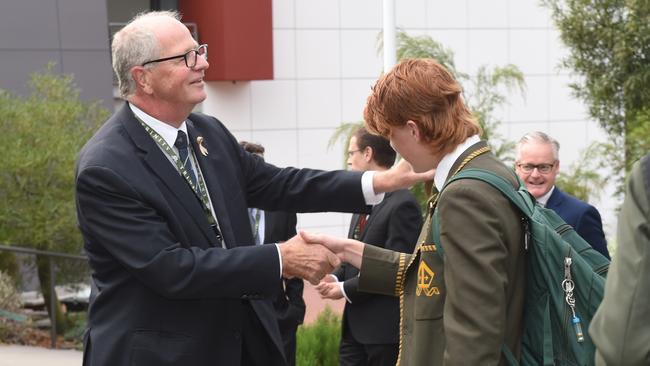 Mr Brown can’t resist an inspection of one student’s locks. Picture: Tony Gough