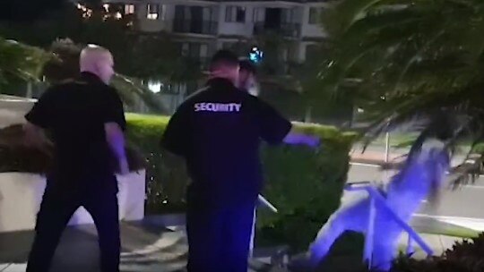 A man is sent down a set of stairs after being pushed by security at The Grand Hotel at Labrador on the Gold Coast. Image: Channel 9