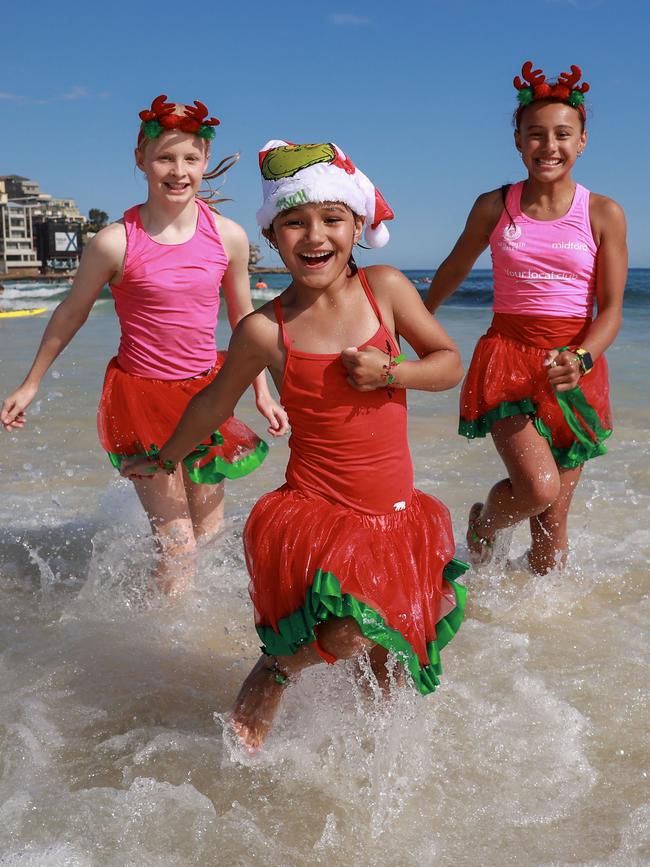 Chloe Anthony, 11, Eliza Na'a, 6, and Lilly Na'a, 10, make a splash at Bondi. Picture: Justin Lloyd