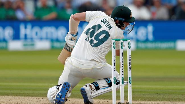 Steve Smith falls to the pitch after being hit by a ball during the second Ashes cricket Test match between England and Australia at Lord's.