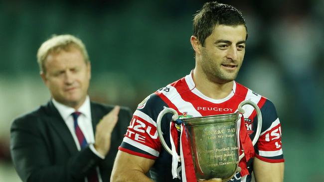 Anzac Day NRL Match. St George Illawarra Dragons v the Sydney City Roosters at Allianz Stadium today. Pictured is NRL CEO David Smith handing over the Anzac Cup to the Roosters Captain Anthony Miniachiello.