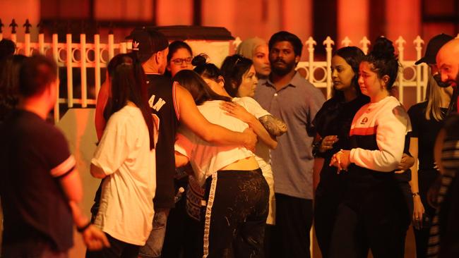 Relatives and friends console each other. Picture: Wayne Taylor