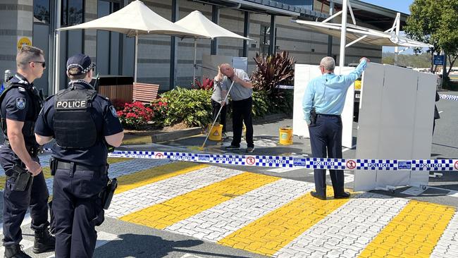 Staff seen cleaning up the scene after a stabbing at the Westfield Helensvale shopping centre on the Gold Coast. Picture: Keith Woods.