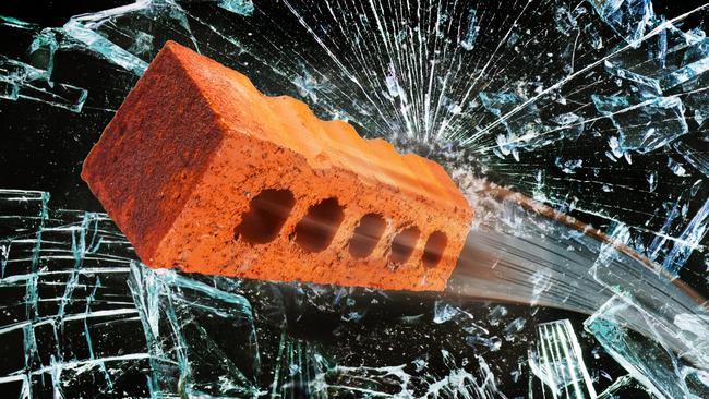 Flying brick through broken glass window. Picture: iStock