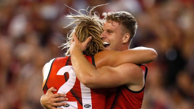 Relief for Dyson Heppell and Jake Stringer after Essendon’s win over Melbourne. Picture: Michael Willson (Getty).