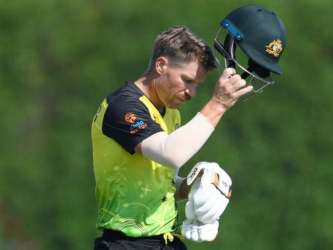 Australia's David Warner walks back to pavilion after his dismissal during the warmup cricket match between India and Australia for the ICC men's Twenty20 World Cup at the ICC Cricket Academy Ground in Dubai on October 20, 2021. (Photo by Aamir QURESHI / AFP)