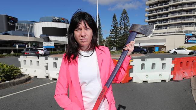 Tara Diklich from the Pink hotel ready to cut through the crap and chop down the border walls at the QLD/NSW border at Coolangatta.Picture: Glenn Hampson