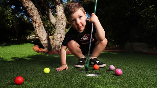 Young golf fan Thomas Kainem, 4, at a mini golf course. Picture: Nikki Davis-Jones