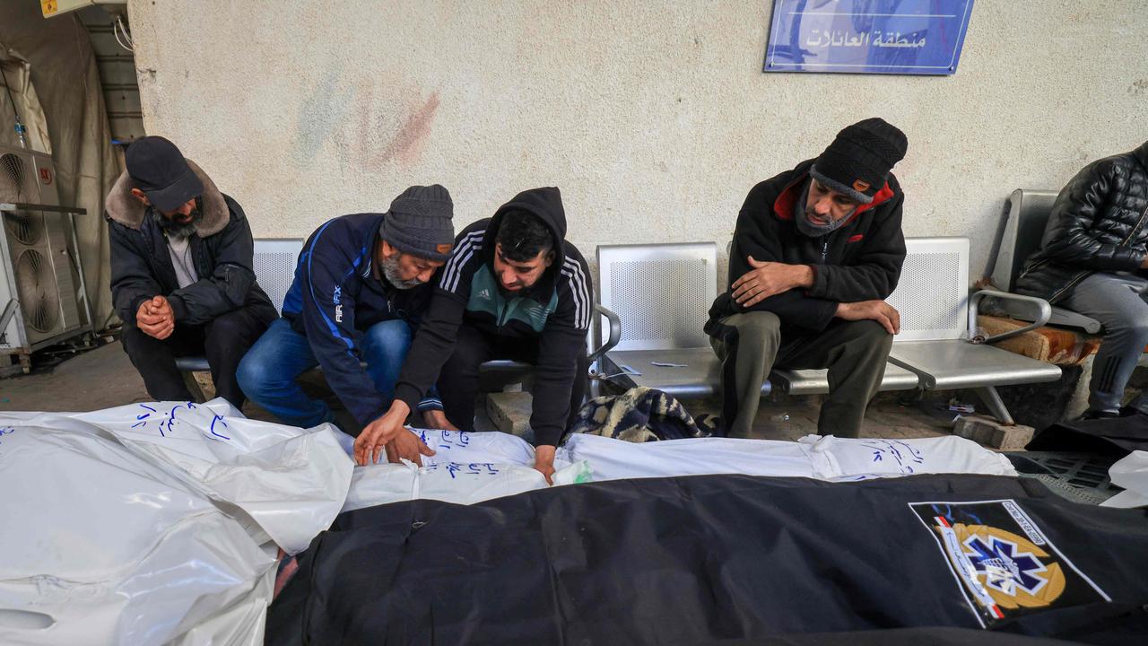 Relatives mourn over the shrouded bodies of loved ones killed during Israeli bombardment. Picture: AFP