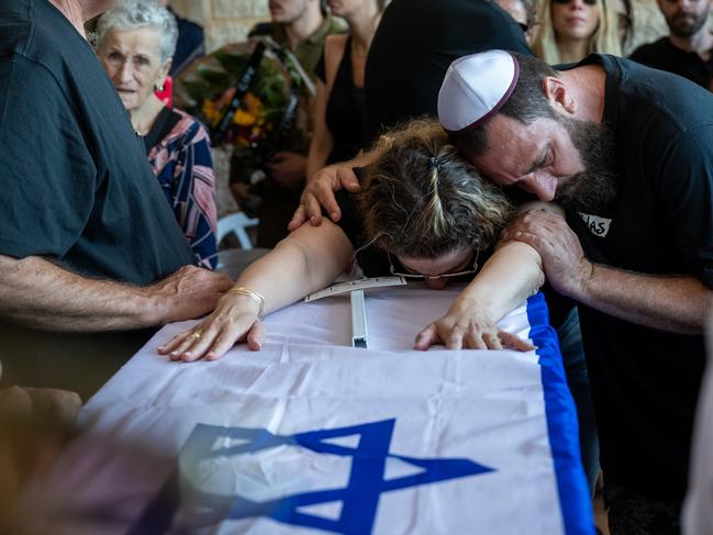 A family grieves during the funeral at the Hod Ha'sharon cemetery in Israel.