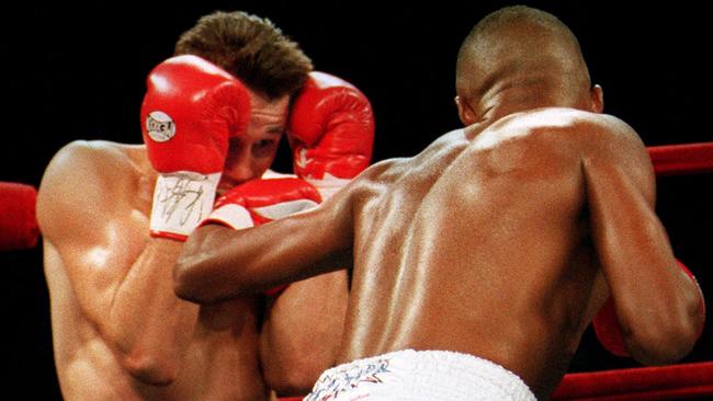 Troy Waters covers up against Felix Trinidad.