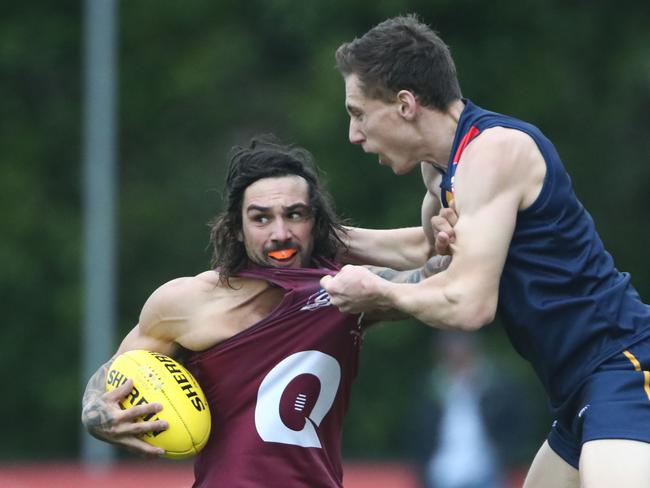 QAFL representative player Alex McKay being tackled during a clash with the Adelaide Football League team. Picture credit: AFLQ Media.