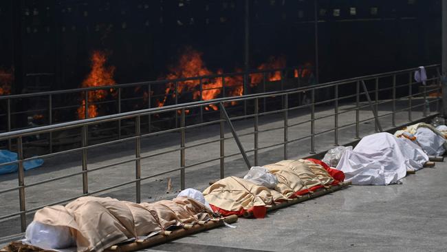 Bodies of COVID-19 victims lined up before cremation at a cremation ground in New Delhi. Picture: AFP.