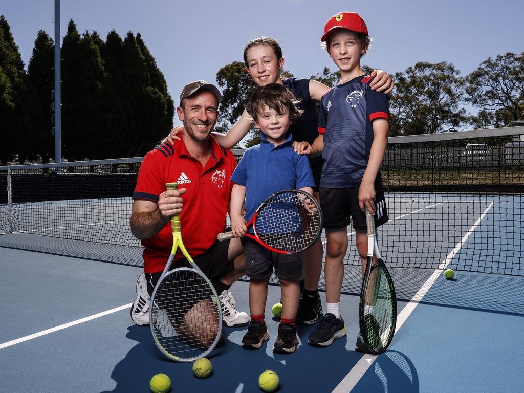 Zan Boag, of Kingston, with his children Huxley, 3, Escher, 10, and Wolfe, 8, at the Domain Tennis Centre. Picture: Zak Simmonds