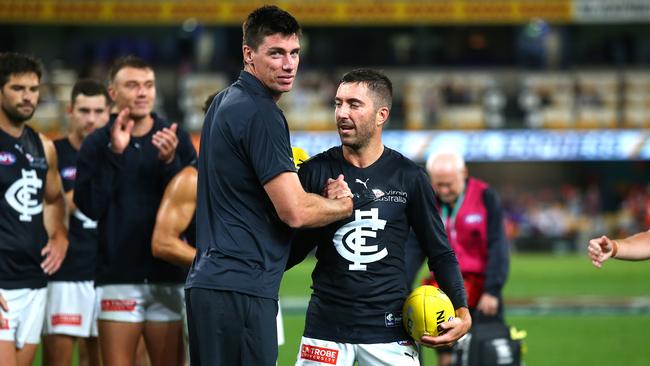 Retiring team mates Matthew Kreuzer and Kade Simpson are clapped off the ground after the Blues’ Round 18 match. (Photo by Jono Searle/AFL Photos/via Getty Images)