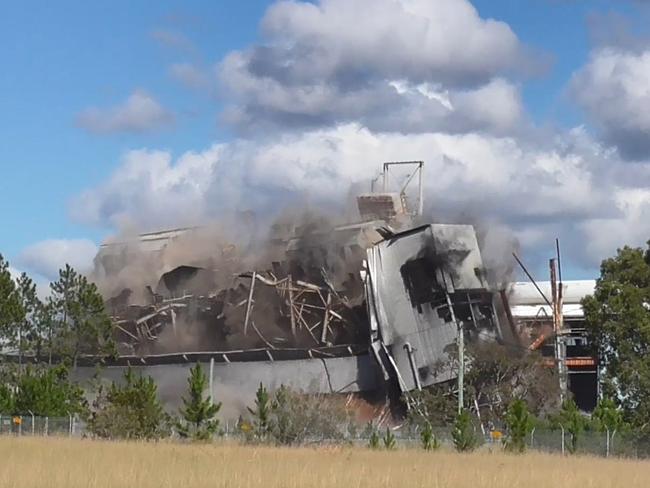 Going: Munmorah Power Station boiler complex coming down in a controlled explosion.