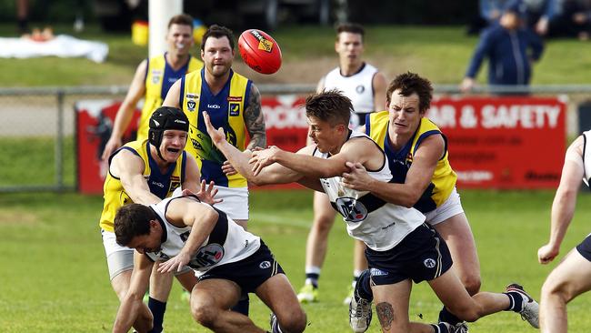 It was tight in the clinches as a Northern Football League player takes possession against the MPNFL at Rye on Saturday. Picture: Paul Loughnan