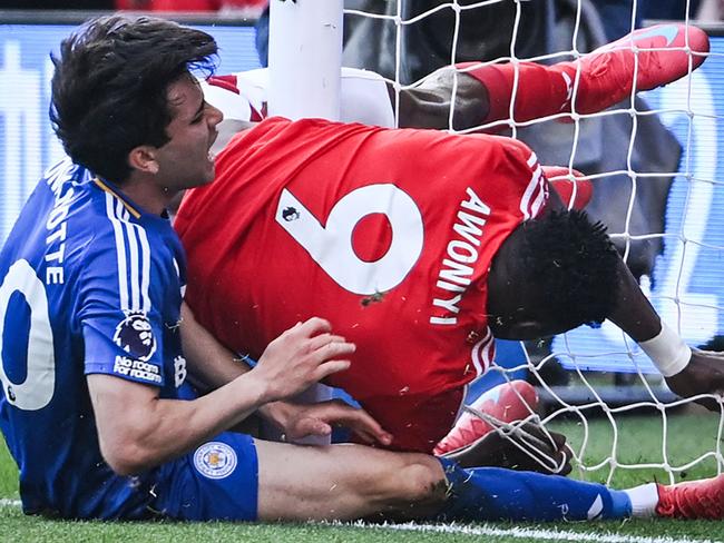 Nottingham Forest's Nigerian striker #09 Taiwo Awoniyi (C) and Leicester City's Argentinian midfielder #40 Facundo Buonanotte (L) collide in the post of the goal during the English Premier League football match between Nottingham Forest and Leicester City at The City Ground in Nottingham, central England, on May 11, 2025. (Photo by JUSTIN TALLIS / AFP) / RESTRICTED TO EDITORIAL USE. No use with unauthorized audio, video, data, fixture lists, club/league logos or 'live' services. Online in-match use limited to 120 images. An additional 40 images may be used in extra time. No video emulation. Social media in-match use limited to 120 images. An additional 40 images may be used in extra time. No use in betting publications, games or single club/league/player publications. /