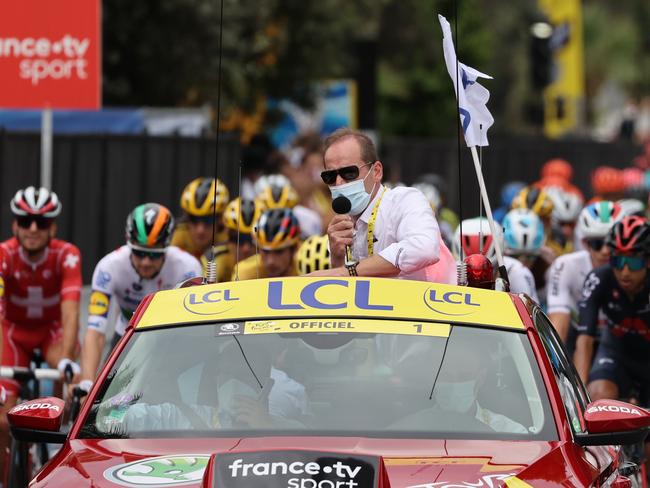 (FILES) In this file photograph taken on August 29, 2020, Tour de France director Christian Prudhomme wearing a face mask speaks from the official car prior the start of the 1st stage of the 107th edition of the Tour de France cycling race, 156 km between Nice and Nice. - Tour de France director Christian Prudhomme has tested positive for Covid-19 but all the riders in the peloton were negative, organisers said on September 8, 2020. Prudhomme must now leave the race for a week to go into quarantine. (Photo by KENZO TRIBOUILLARD / AFP)