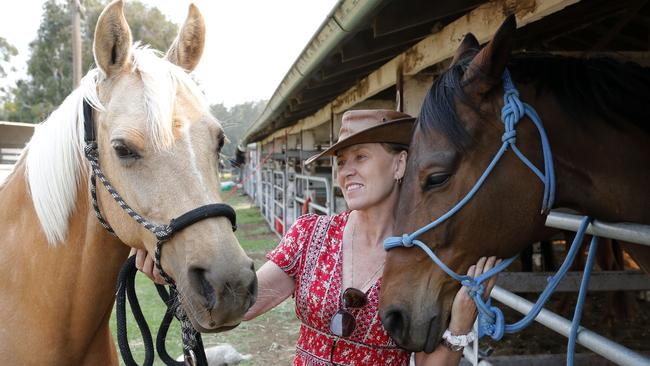 Leanne Waters with two of her horses, Rosco and Sophie, who she evacuated from her Old Bar property and sought refuge at the livestock evacuation shelter at Taree Showground on Sunday. Picture: AAP/Darren Pateman