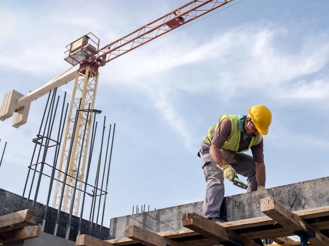 Worker At Construction Site Is Fixing The Form For The Beam