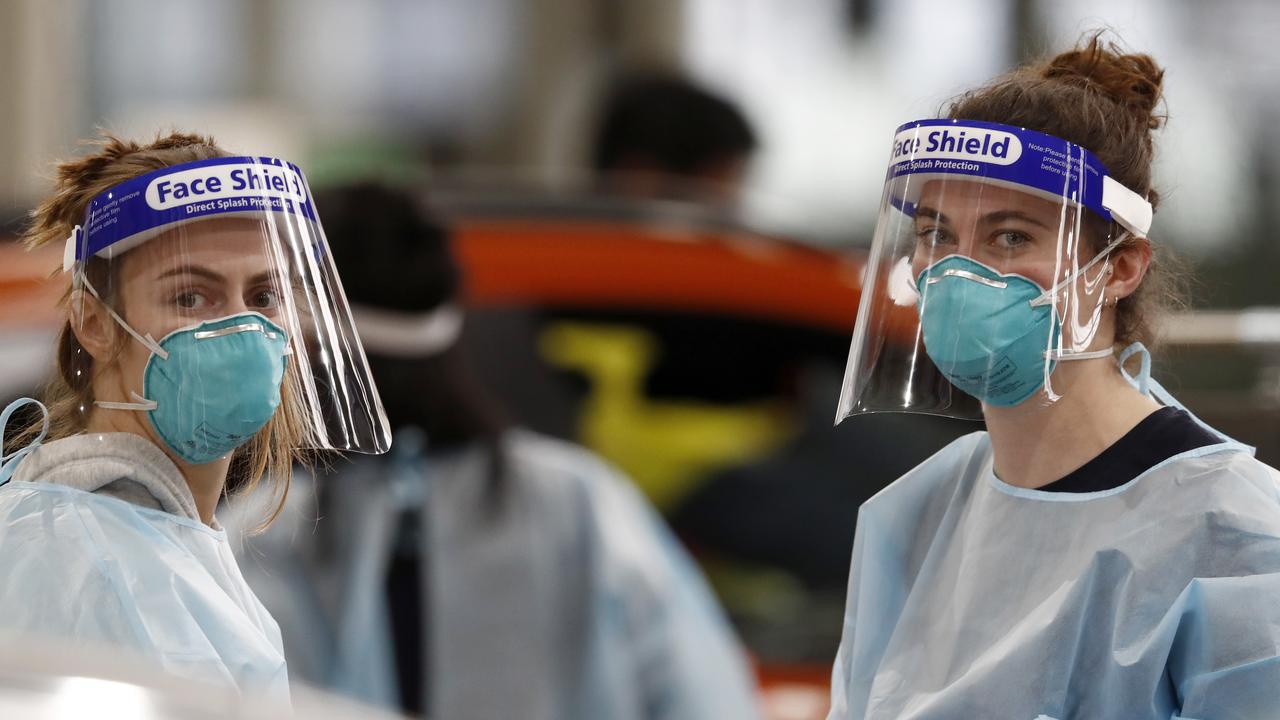 Medical staff perform COVID-19 testing at a drive through testing site in South Melbourne. Picture: Darrian Traynor/Getty Images