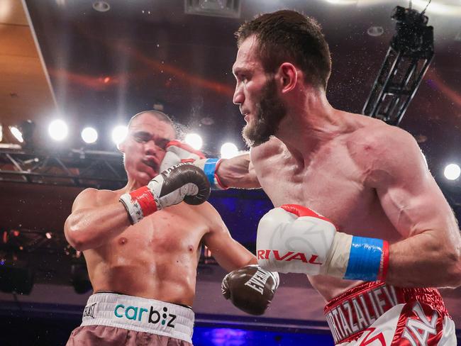 Tim Tszyu takes a heavy punch from Bakhram Murtazaliev during their bout. Picture: Alex Menendez/Getty Images