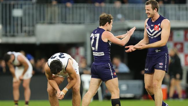 PERTH, AUSTRALIA - JUNE 10: Lachie Neale and Michael Apeness of the Dockers celebrate winning the round 12 AFL match between the Fremantle Dockers and the Adelaide Crows at Optus Stadium on June 10, 2018 in Perth, Australia.  (Photo by Paul Kane/Getty Images)