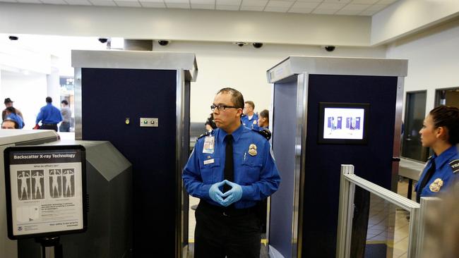 22/11/2010 WIRE: LOS ANGELES - NOVEMBER 22: TSA agents stand near an Advanced Imaging Technology (AIT) full-body scanner at Los Angeles International Airport (LAX) on November 22, 2010 in Los Angeles, California. AIT scanners see through clothing to photograph the entire body to reveal undisclosed objects. Increasing use of the scanner at airports by the Transportation Security Administration (TSA) is being met with outrage by many US travelers. Passengers who refuse an X-ray scan are required to undergo an intimate pat down by TSA agents. David McNew/Getty Images/AFP== FOR NEWSPAPERS, INTERNET, TELCOS & TELEVISION USE ONLY ==  Pic. Afp