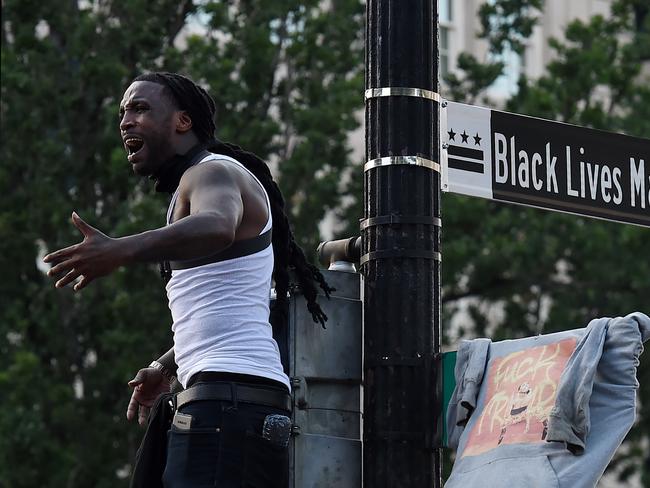 Mike D'angelo screams near a street sign that has been renamed 'Black Lives Matter Plaza' near the White House. Picture: AFP