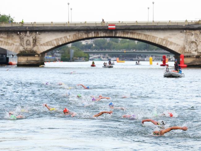 Triathletes swim in the Seine River. (Photo by Ezra Shaw/Getty Images)