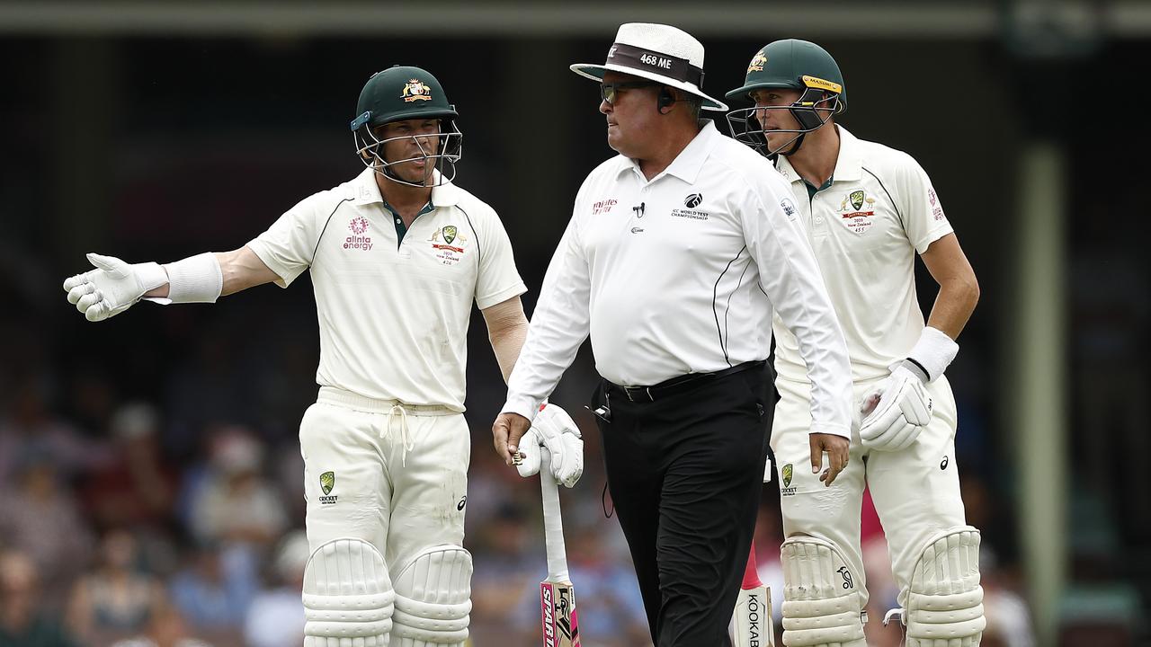 David Warner speaks with Umpire Marais Erasmus after Australia were penalised five runs for running on the pitch.