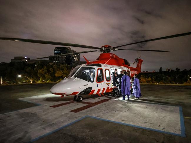 WARNING. HOLD FOR HS FEATURE. CONTACT PIC DESK BEFORE USE. Overnight in the Alfred Hospital Emergency Department. A emergency car accident patient arrives by Air Ambulance on the helipad with ED medical staff walking out to receive the patient.                        Picture: David Caird