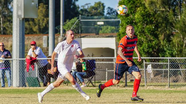 Nerang Eagles playmaker Shaun Robinson strides ahead of his Burleigh opponent. Photo: Luke Sorensen.