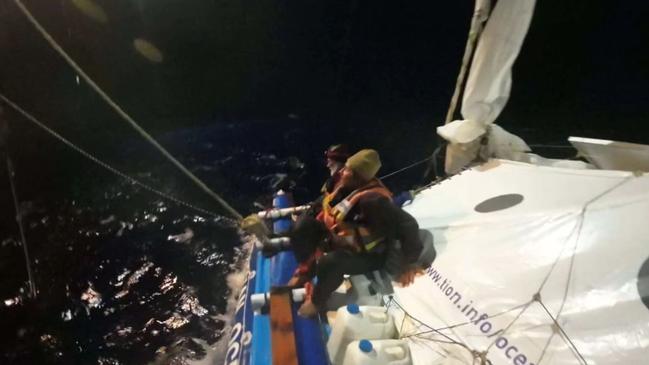 Two Russian and one French sailor were rescued by Panamanian cargo ship Dugong Ace after their 9m catamaran was attacked by sharks more than 800km south of Cairns.