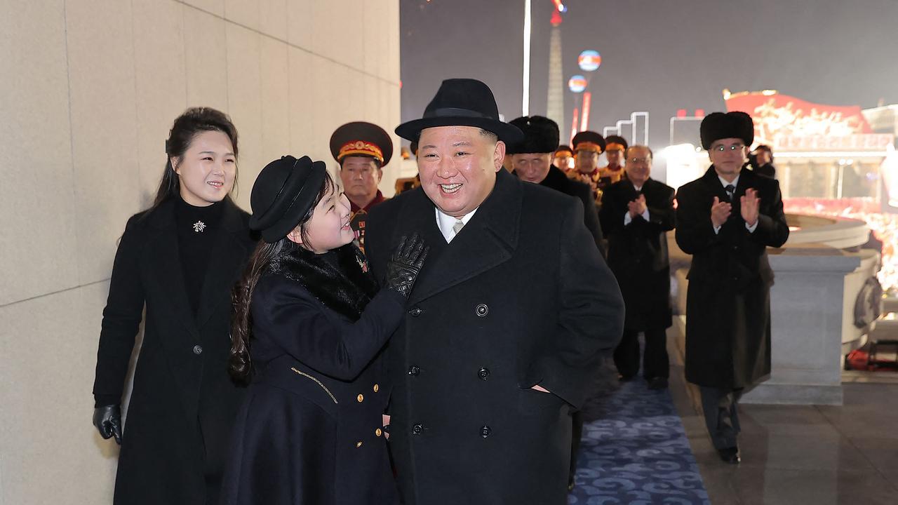 Dad and daughter attend a military parade celebrating the 75th anniversary of the founding of the Korean People's Army in Kim Il Sung Square in Pyongyang. Picture: KCNA via KNS / AFP