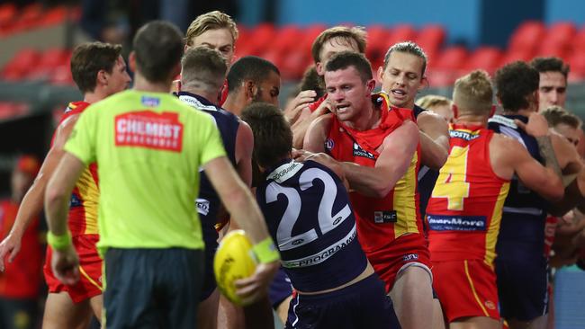 GOLD COAST, AUSTRALIA - JUNE 27: Pearce Hanley of the Suns and Caleb Serong of the Dockers grapple during the round 4 AFL match between the Gold Coast Suns and Fremantle Dockers at Metricon Stadium on June 27, 2020 in Gold Coast, Australia. (Photo by Chris Hyde/Getty Images)